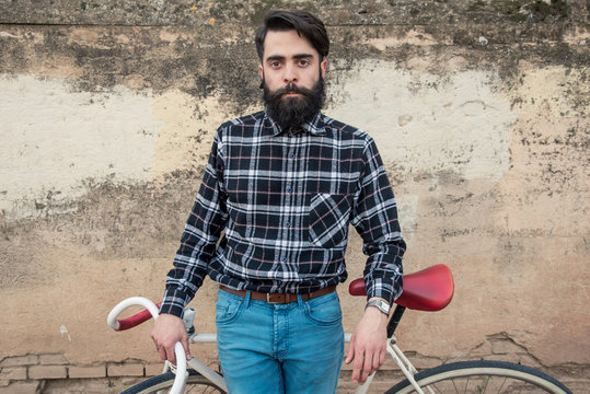 Portrait of young man with fixed gear bicycle