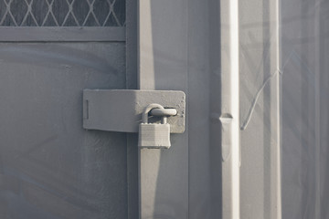 Padlock on warehouse door, close up