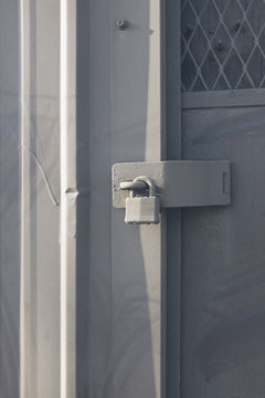 Padlock on warehouse door, close up