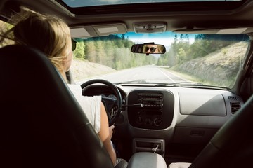 Rear view of woman driving car