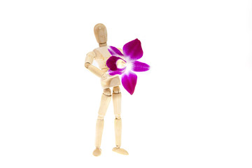 Wooden mannequin with purple orchid