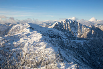 Aerial landscape view of the mountains north of Vancouver, British Columbia, Canada, during a cloudy winter day.
