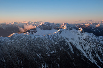 Aerial landscape view of the Vancouver North Shore Mountains in BC, Canada during sunset.