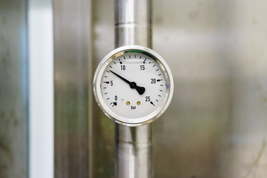 Pressure gauge in the pipeline, measuring instrument close up on pneumatic control system.