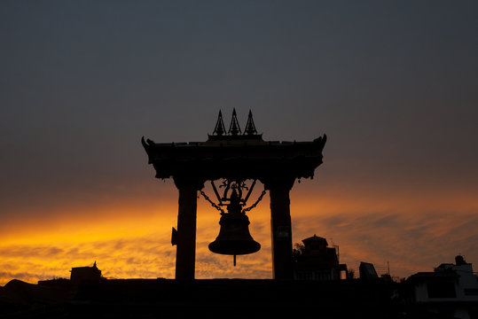 Silhouette of a large bell in Patan Durbar Square.
