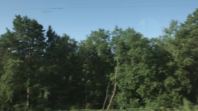 POV: High-speed Train moves near a small town and forest
