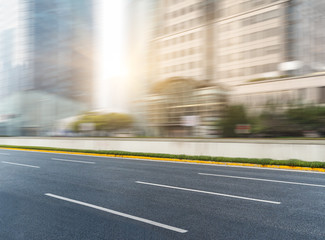 closeup of tarmac road with blurred buildings on background,shanghai,china.
