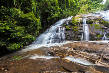 Motion blurred water of Pa Dok Siew Waterfall (Rak Jung waterfall ) beautiful waterfall in deep forest  Doi Inthanon national park . Chiangmai , Thailand
