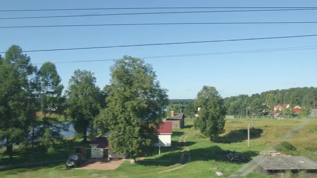 POV: High-speed Train moves on a bridge over a river in the summer