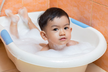 Closeup 2 year old Child bathing in bathtub.