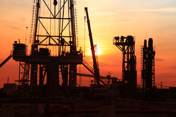 the silhouette of oilfield derrick
