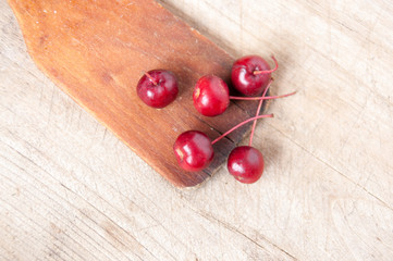 Cherry berries lie on a wooden background