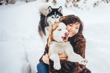 Young girl hugging a dog Husky winter