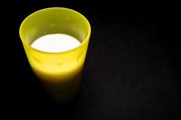 a glass of milk isolated on black