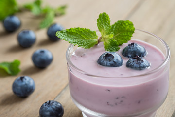 Yogurt with fresh blueberries in glass