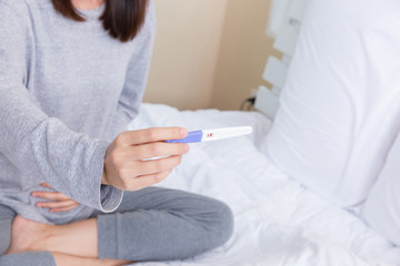 Young woman with the pregnancy test.
