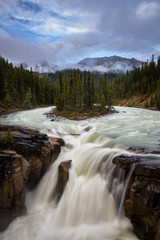 Beautiful waterfall during a cloudy sunset at Sunwapta Falls in Banff National Park, Alberta, Canada.