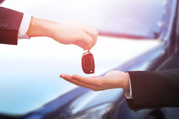 Car Dealer Giving Keys To Businessman