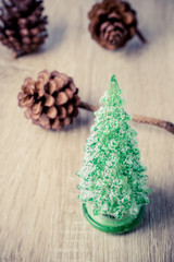 Christmas decoration  with christmas tree and pine cones on wooden background
