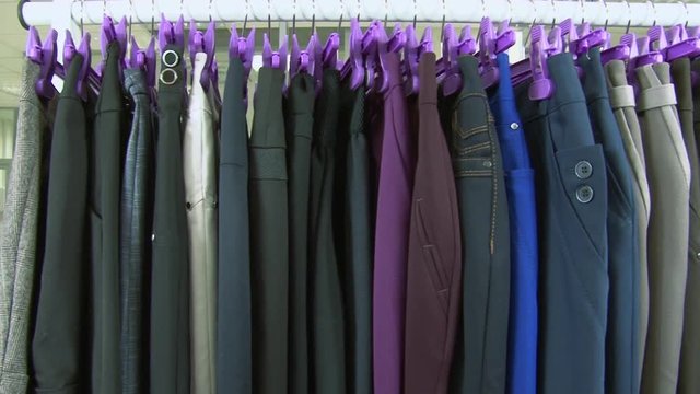 Old-fashioned ugly horrible women clothing on rack in collective farm Uryupinsk. Anti-advertising. How not to do.