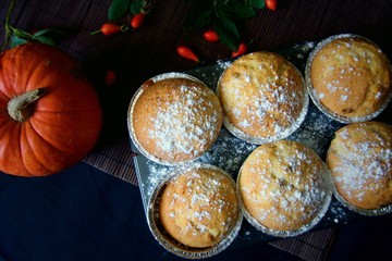 Homemade Lemon muffins in baking dish close up on black background.