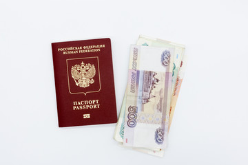 On the table a passport with banknotes on a white background