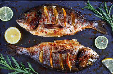 roasted sea bream fish with lemon slices