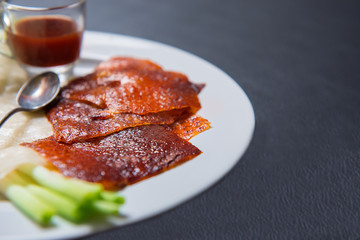 Peking Duck - Chinese roast duck served with cucumber, spring onion and hoisin sauce, wrapped in pancakes.