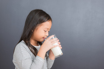 Asian kid cute girl  happy to drink milk