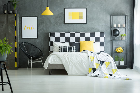 Spacious bedroom with yellow accessories