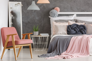 Pretty pink bedroom with chair