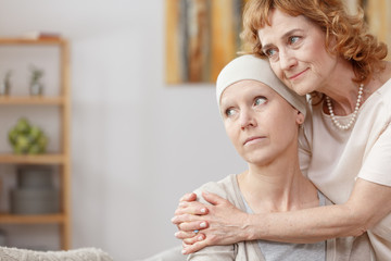 Tumour patient comforted by friend