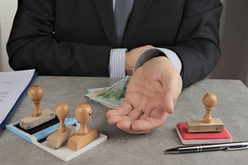Pencil pusher asking for a bribe in euros or in dollars