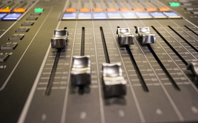 Close up of faders on a sound desk