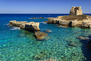 Fototapeta na wymiar The most beautiful coast of Apulia: Roca Vecchia, ITALY (Lecce).Typical seascape of Salento: cliff and ruins of ancient coastal watchtower. 