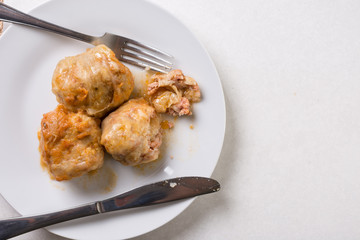 Flat lay above served sarma on the plate on the white marble background