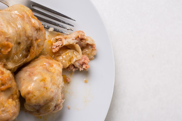 Flat lay above served sarma on the plate on the white marble background