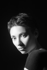portrait of beautiful sensual woman looking at camera on dark background 
