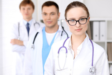 Fototapeta premium Happy doctor woman with medical staff at the hospital