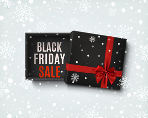 Black Friday sale design. Opened black gift box with red bow.