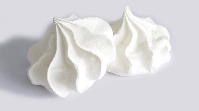 Sweet white meringue is isolated on a white background.