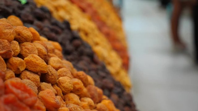 Spices, nuts, dried fruits on display at market on the counter, 4k, slow-motion