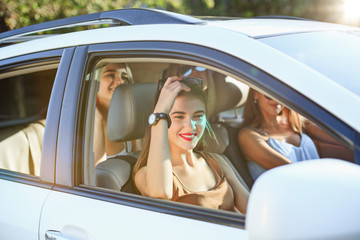 The young women in the car smiling
