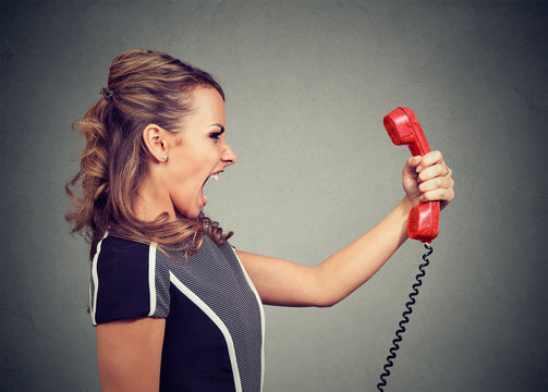 Portrait Of An Angry Woman Yelling At The Phone