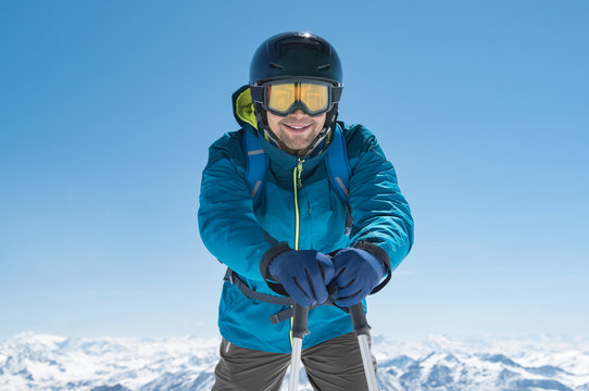Skier standing holding ski poles