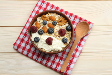 healthy breakfast. oatmeal, blueberries, raspberries and nuts on white wooden table. Top view with copy space