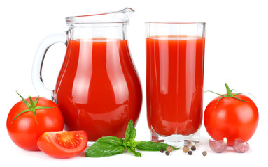Tomato juice in glass jug with tomato, garlic, spices, and basil isolated on white background