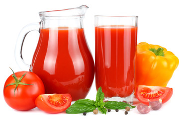 Tomato juice in glass jug with tomato, garlic, spices, and basil isolated on white background
