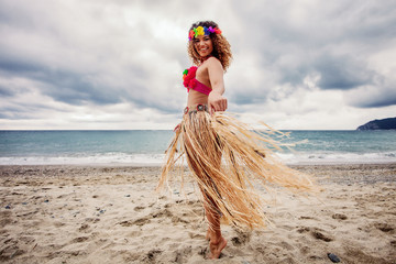 Beautiful hawaiian woman dancing on the beach