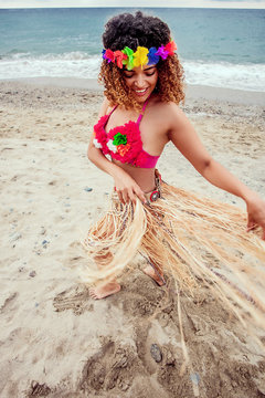 Happy hawaiian woman portrait dancing on the beach